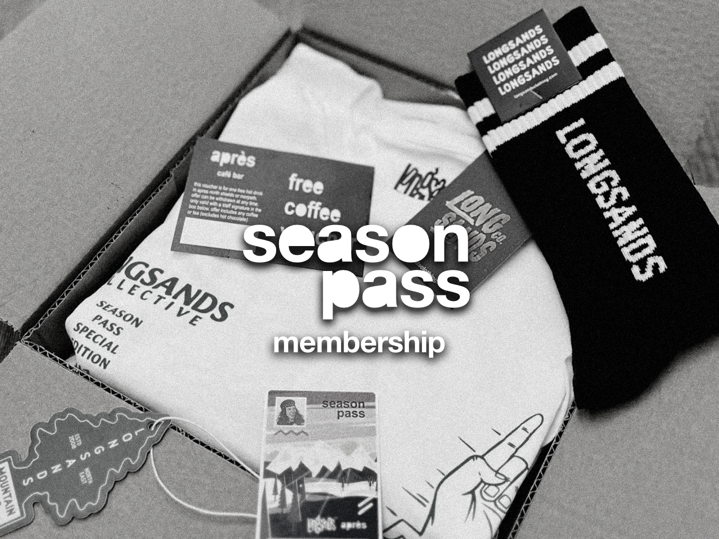 Longsands season pass membership package with t-shirt, socks, and other items on a gray background