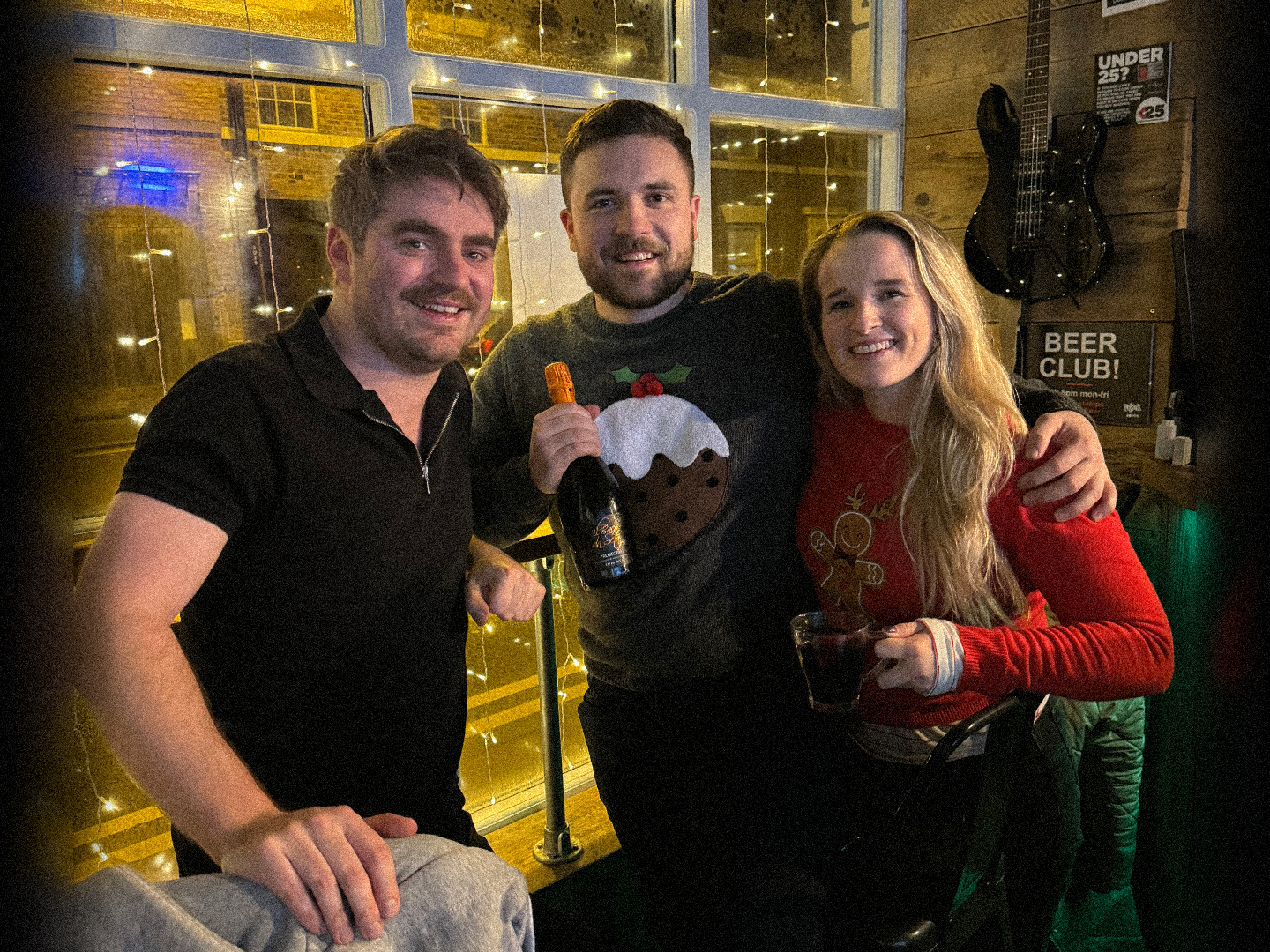 Three people posing together with drinks at Longsands Après Café-Bar.